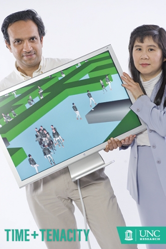 Steve Exom Dinesh Manocha and Ming Lin hold a computer showcasing a modeling and simulation program.