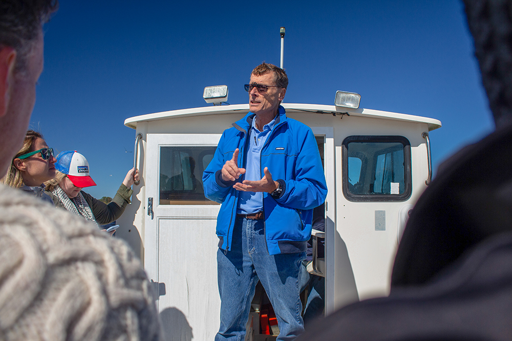 Rick Luettich addresses a crowd on a boat on the Neuse River