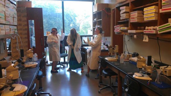 Romero (left), along with post-baccalaureate fellow Olivia Ballew (center) and graduate student Danielle Rognstad (right) celebrate a successful cloning with an impromptu dance party.