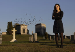 Michelle Freeman stands in a cemetery