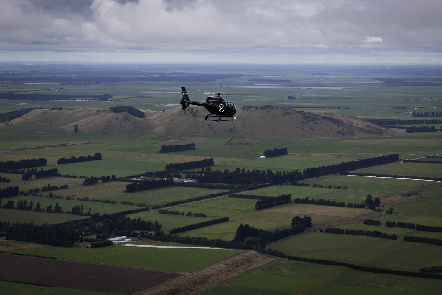 helicopter flies over the South Island of NZ
