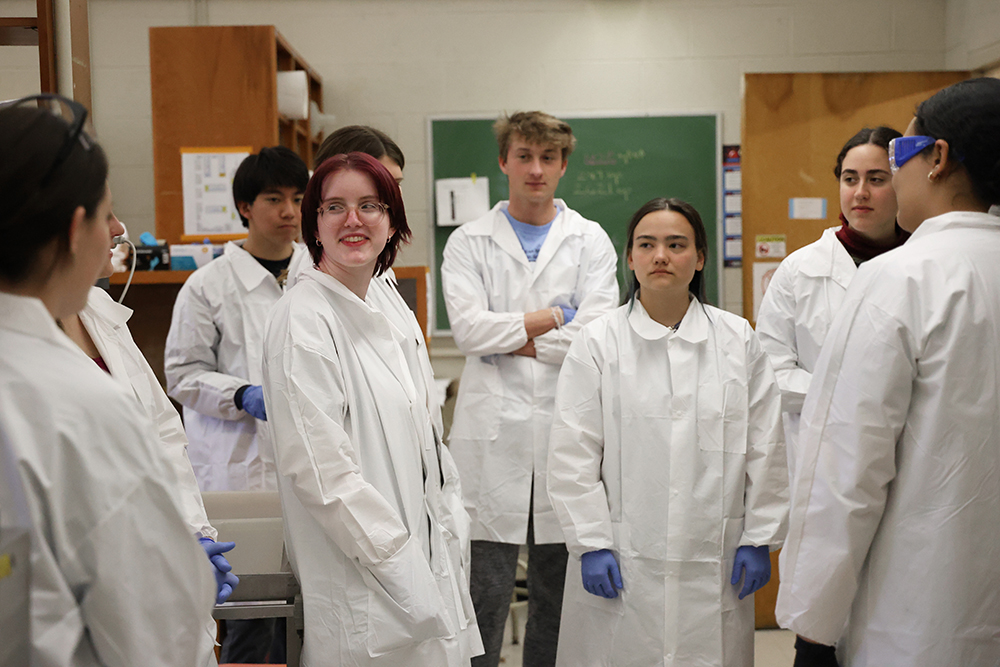 a group of students gather in the lab