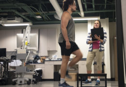 Julianna Prim (right) monitors Ryan Brooks' heart rate on a computer as he steps up on a platform