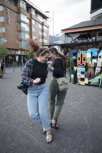 Megan Raisle and Chloe Schneider dance in a square in Quito, Ecuador