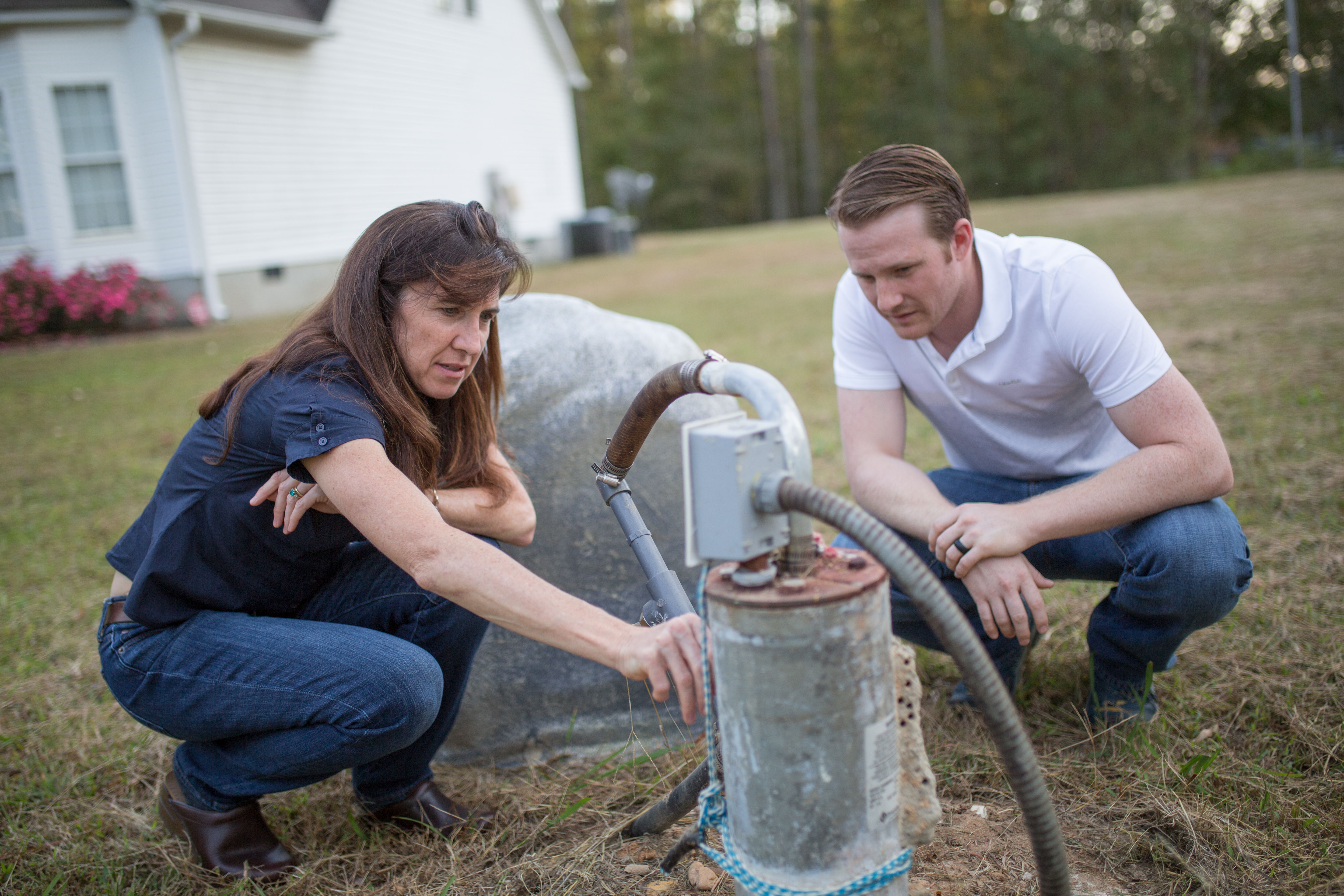 Jacqueline MacDonald Gibson and Frank Stillo test the well water at a home just outside city limits in Wake County.