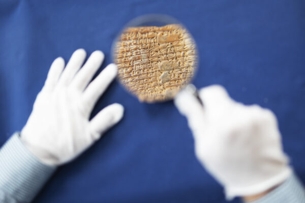 a cuneiform tablet as seen through a magnifying glass