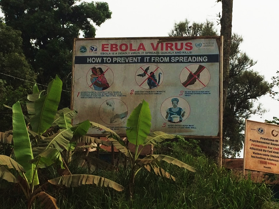 Sign sits out in a country side that says "Ebola Virus, How to Prevent it From Spreading"