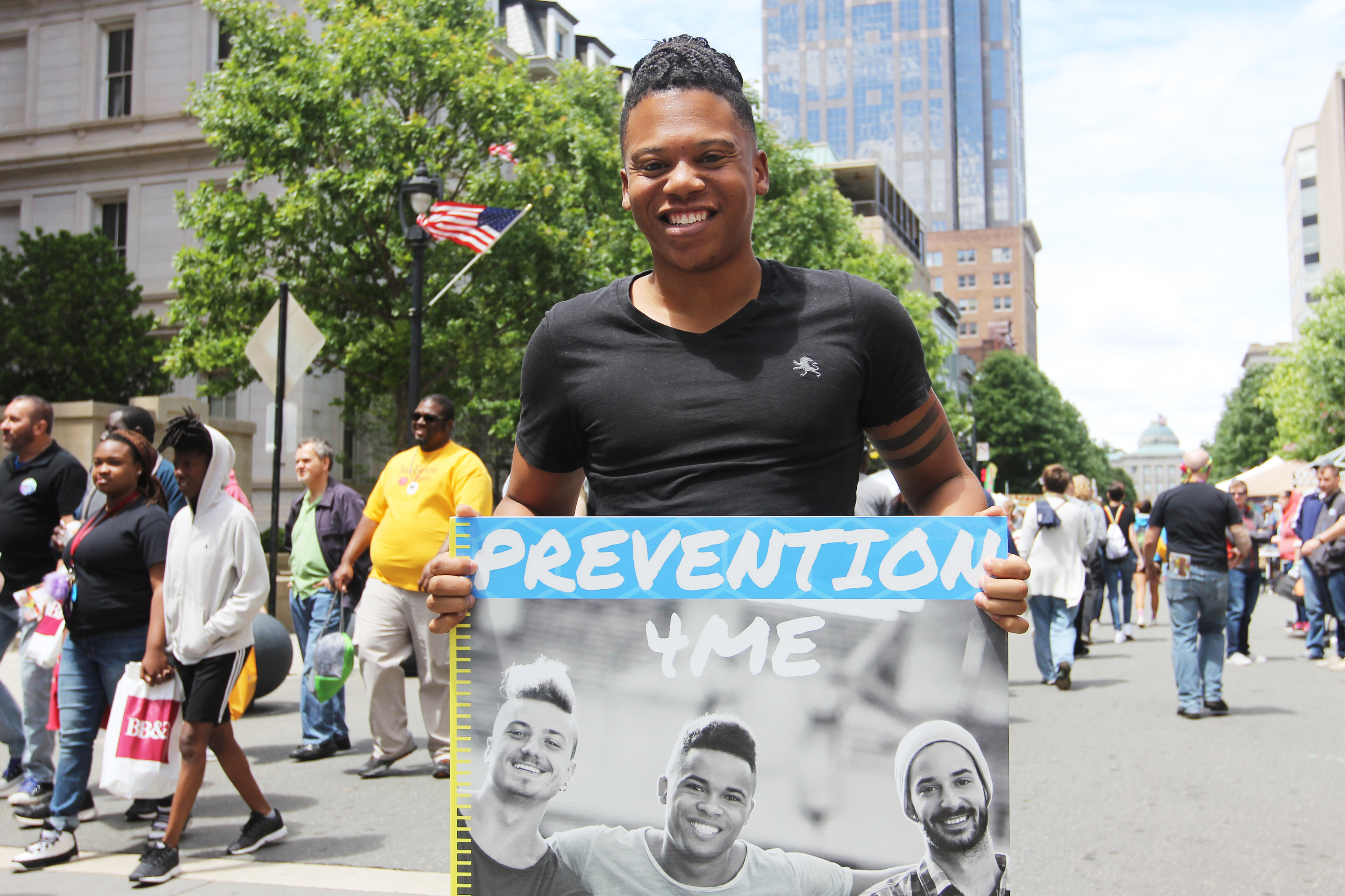 Felton Thomas holds up a sign that reads "Prevention 4 me" at an event that supports the LGBT Center in Raleigh