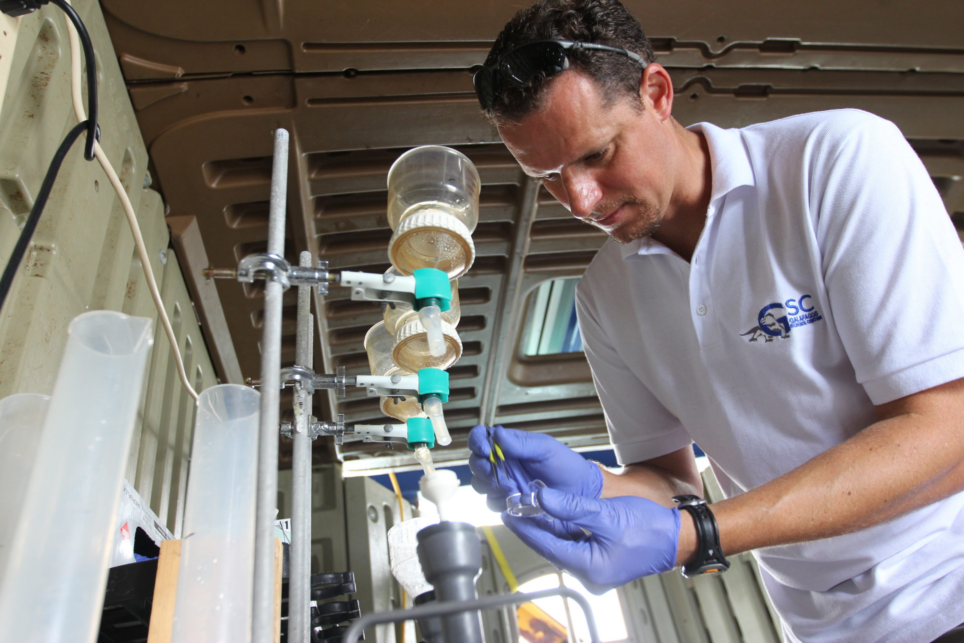 Adrian Marchetti processes a water sample aboard a research boat