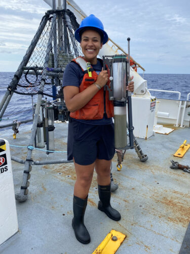 Stephanie Caddell holds a sediment core