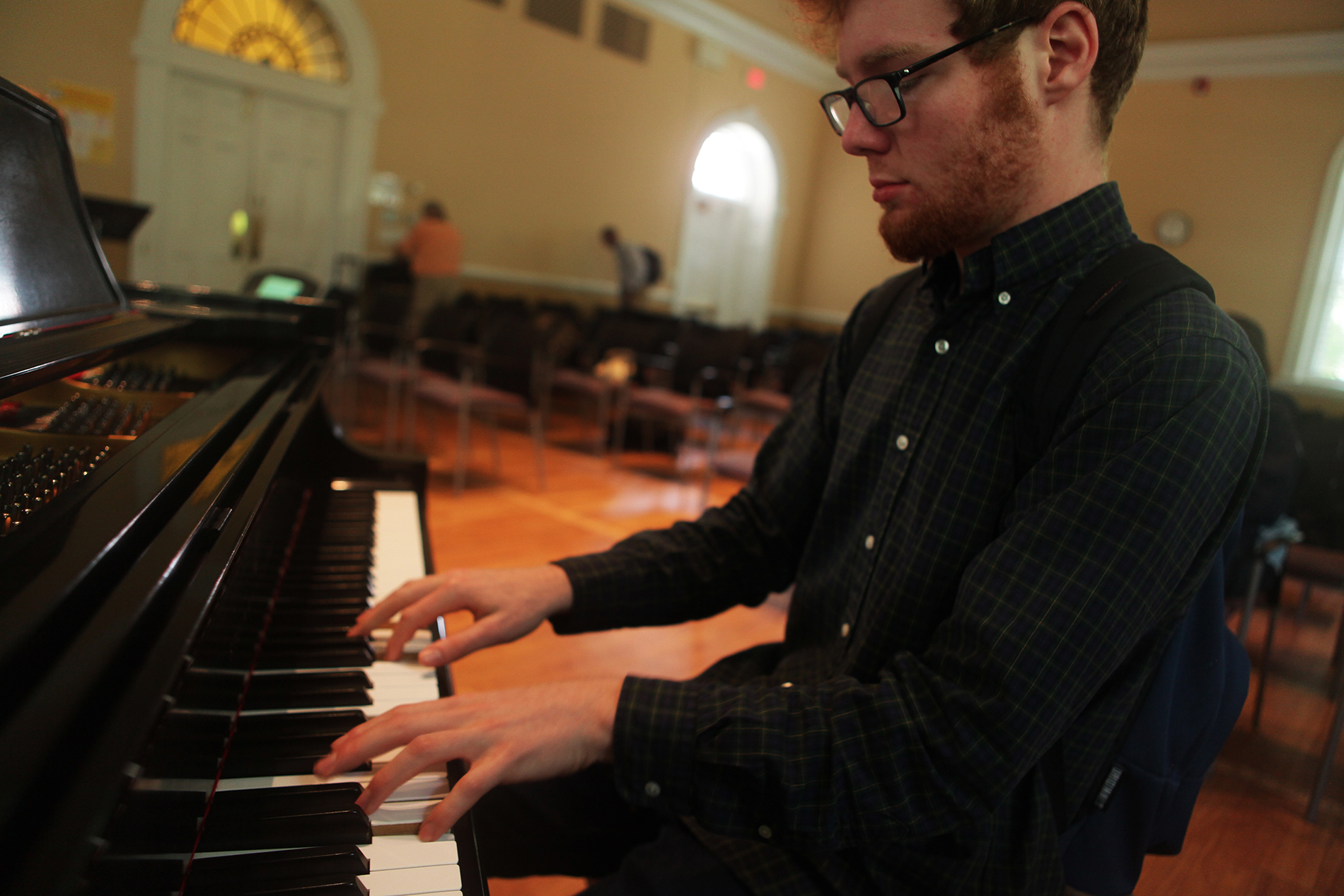 A young man plays the piano