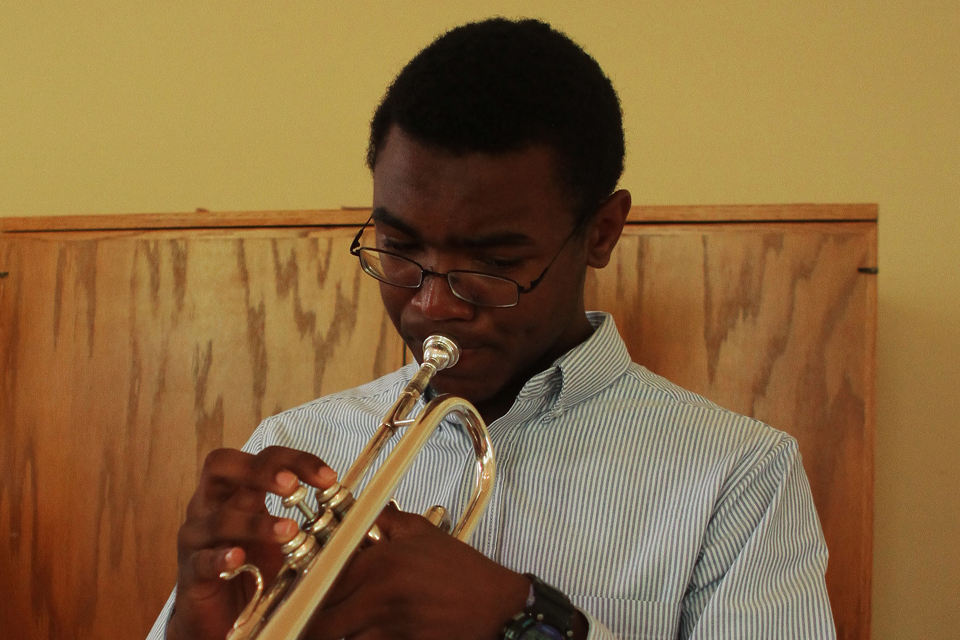 a young man plays the trumpet