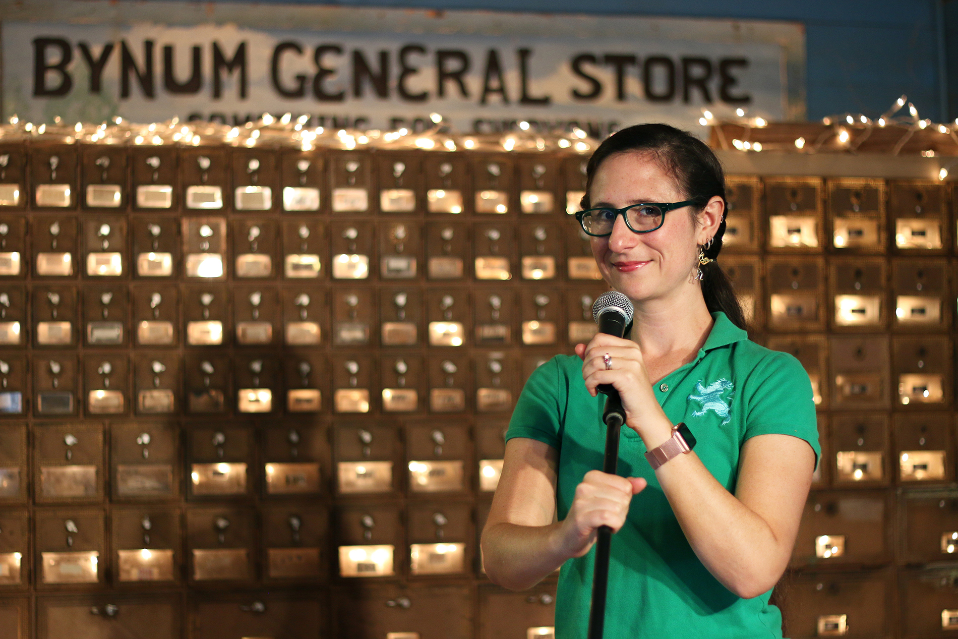 Sarah Beth Nelson braces a microphone