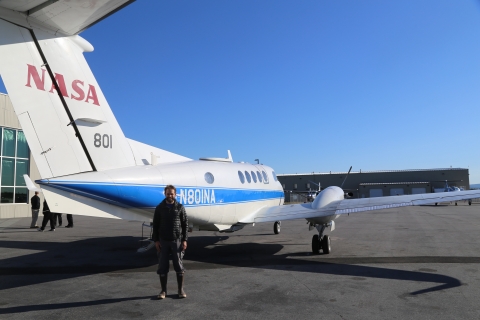 Tamlin Pavelsky stands in front of a NASA KingAir B200