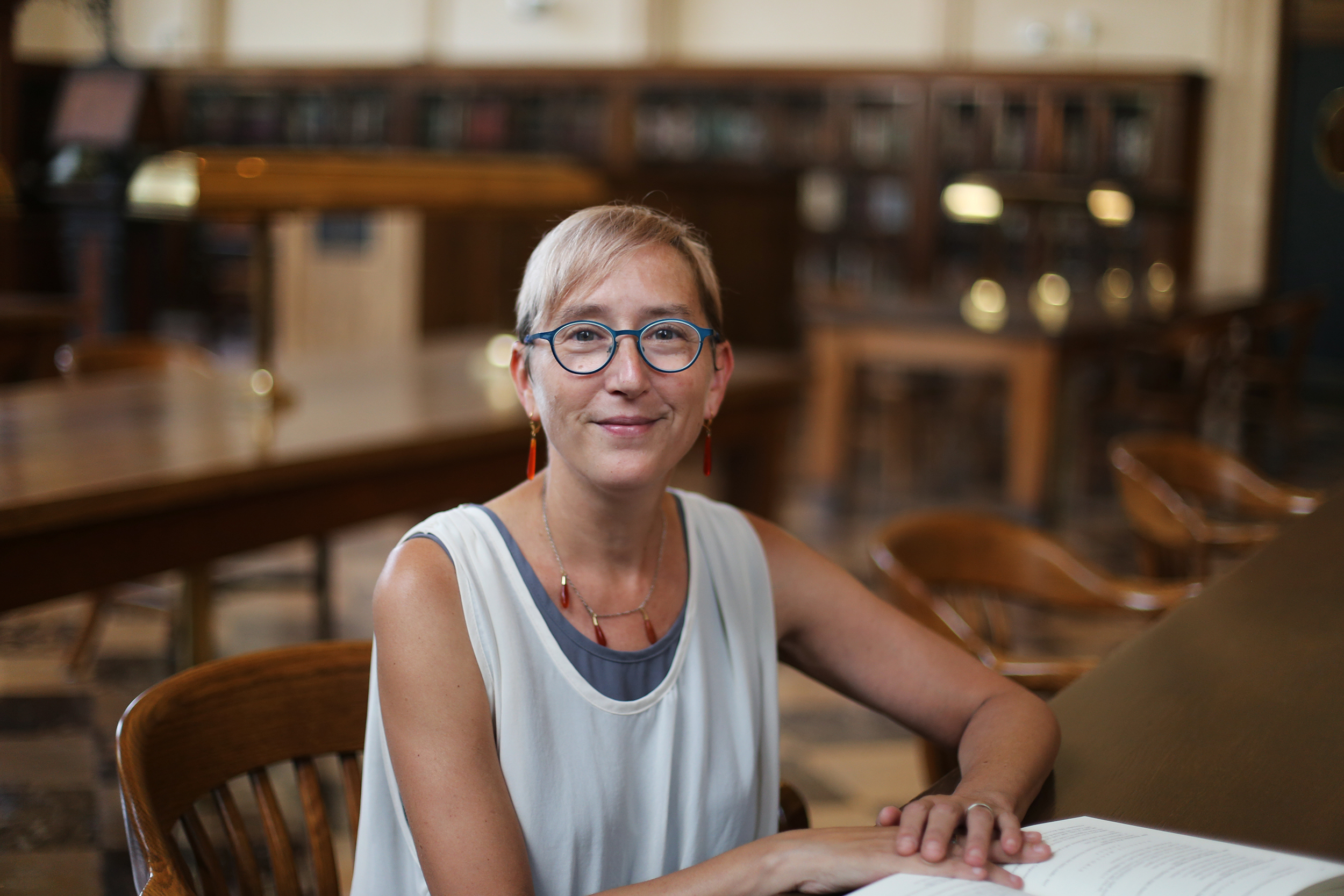 Jessica Wolfe sits at a table in Wilson Library