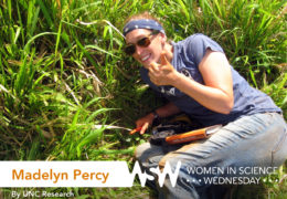 Photo of Madelyn Percy giving a thumbs up as she measures soil drainage on the Galapagos Islands.
