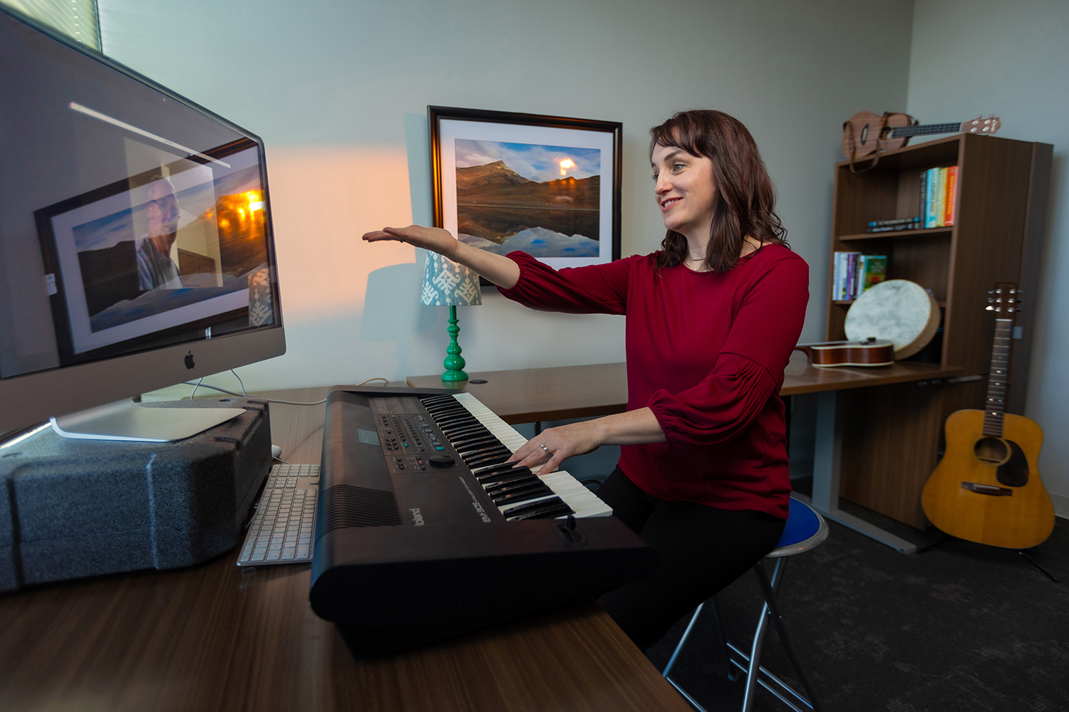 Alie Chandler plays the piano during a virtual session with a client