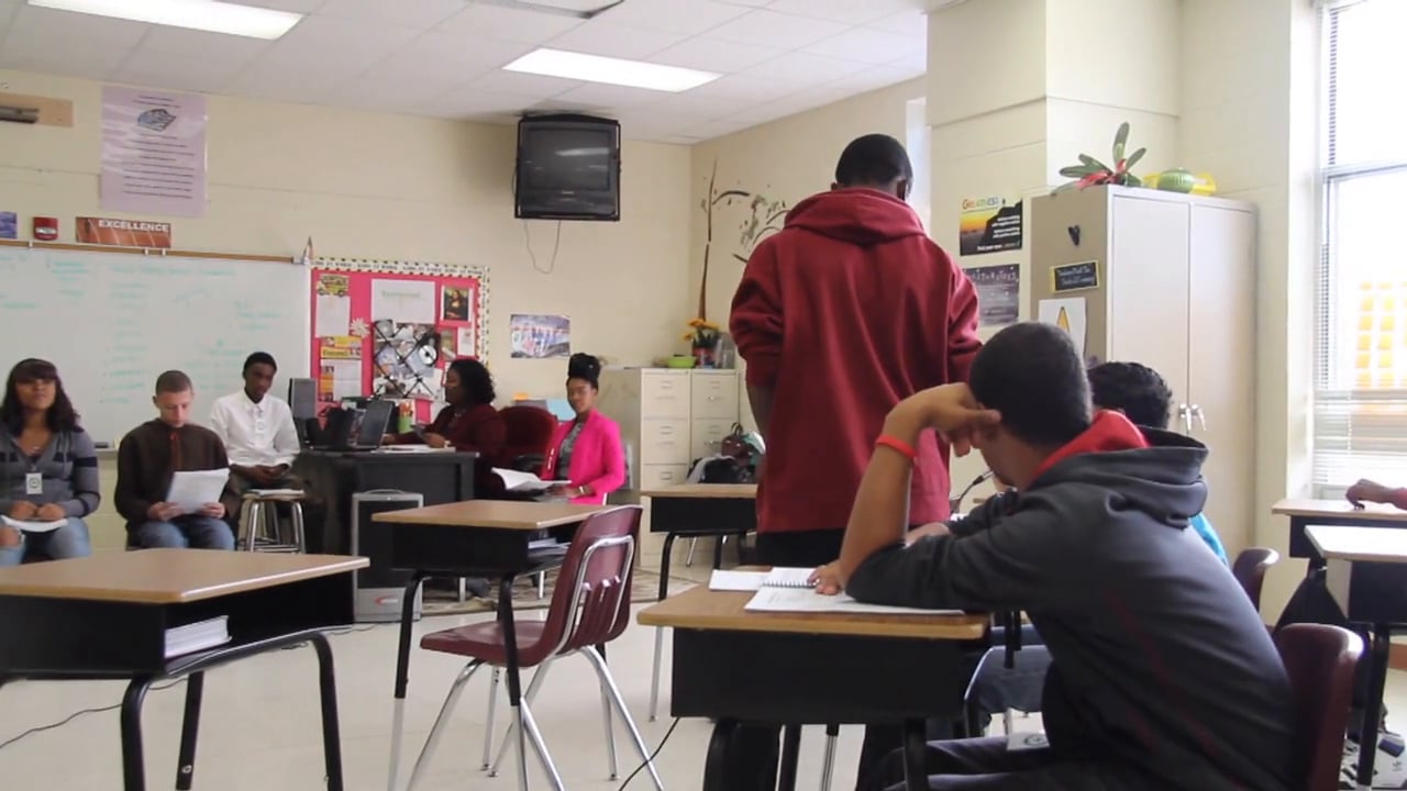 screen grab of students in a classroom. Click to start video.