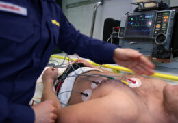 EMT measures the heart rate of a patient