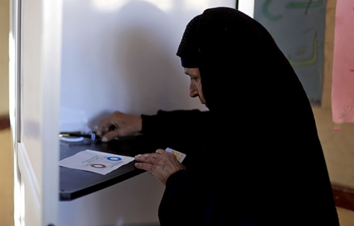 Photo of an older Egyptian woman casting her vote during the second round of a referendum.