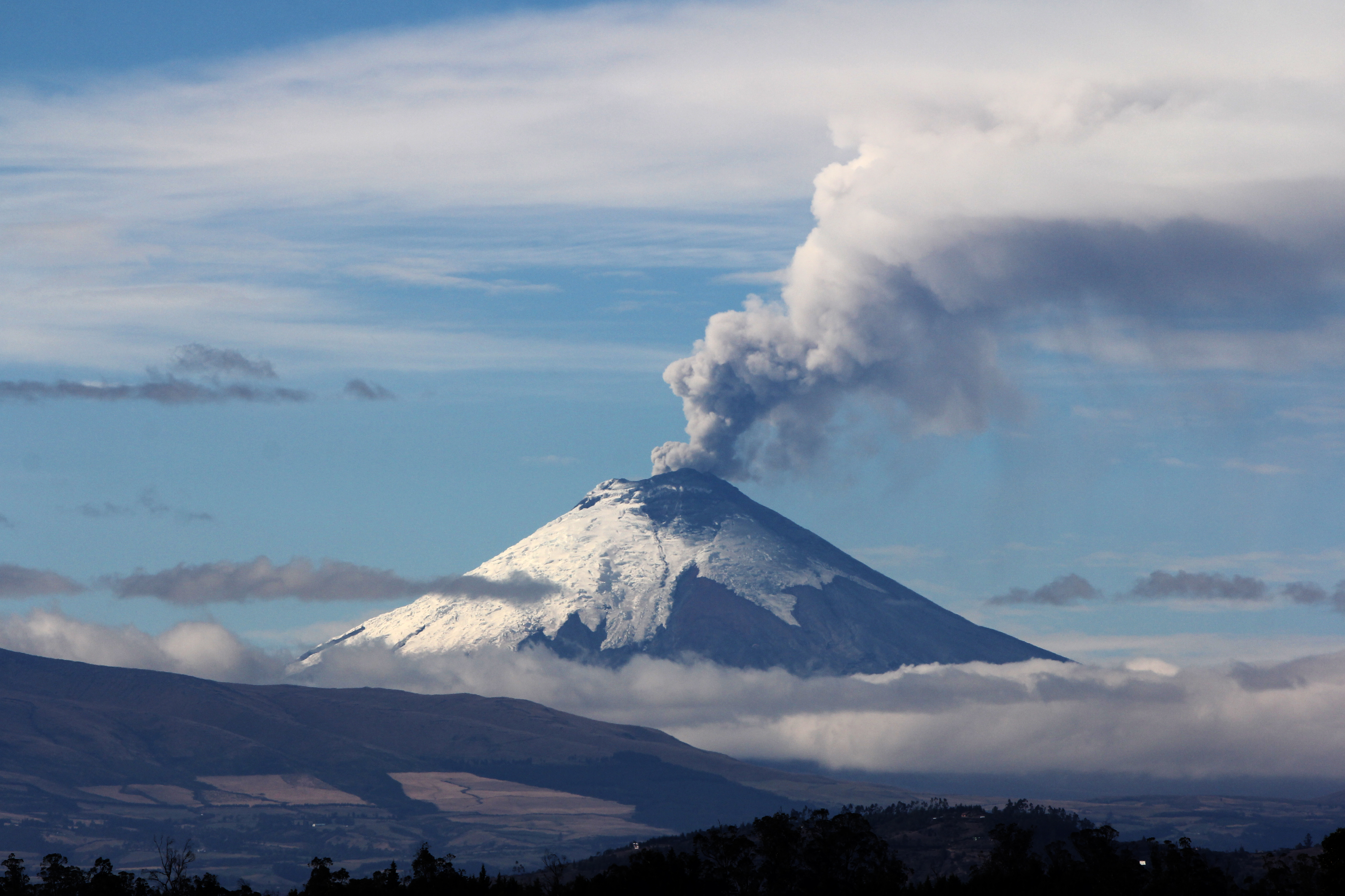 A volcano emitting smoke from it.