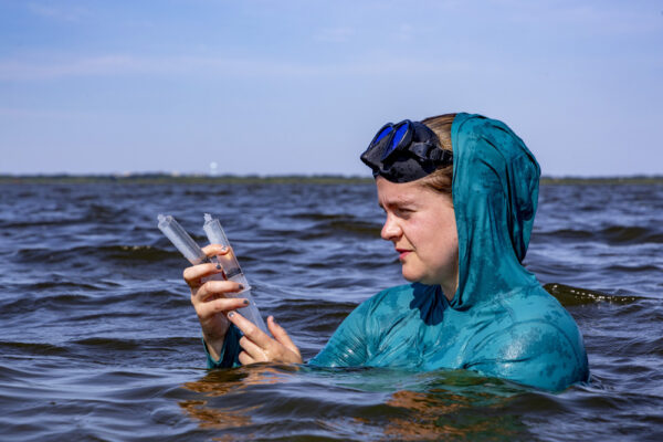 Peggy Mullin collects a water sample