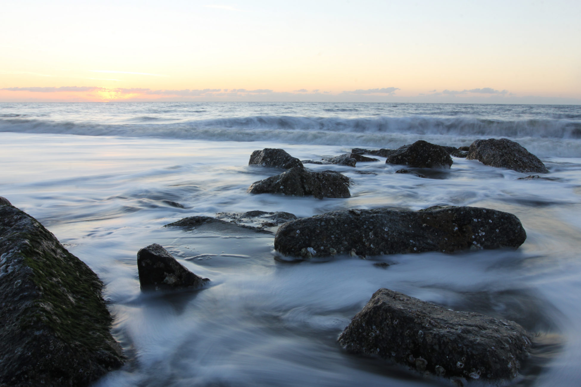 The beach tide starts to recede at the sun rises