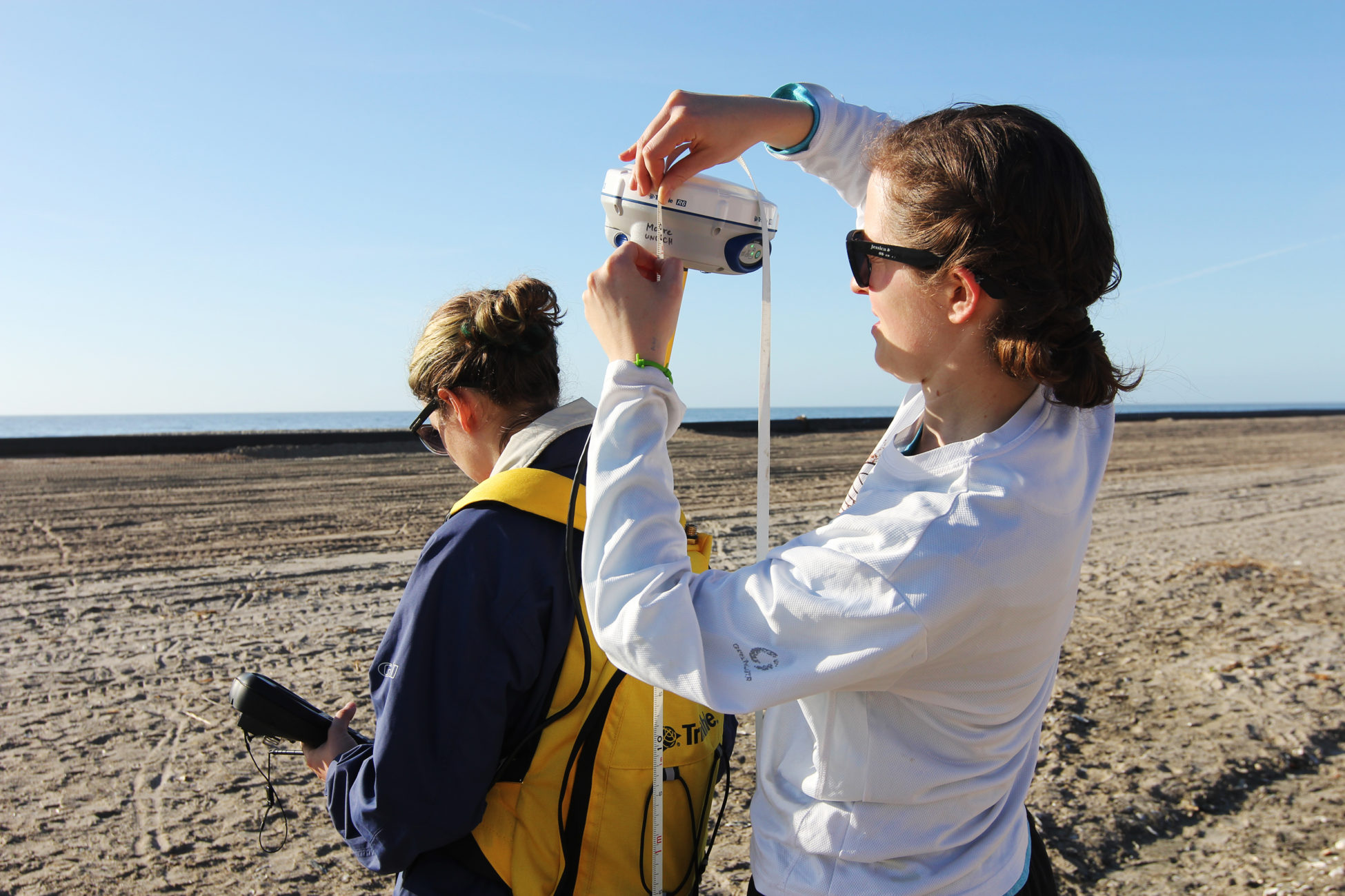 Elsemarie deVries and Atencio prepare to collect topography data