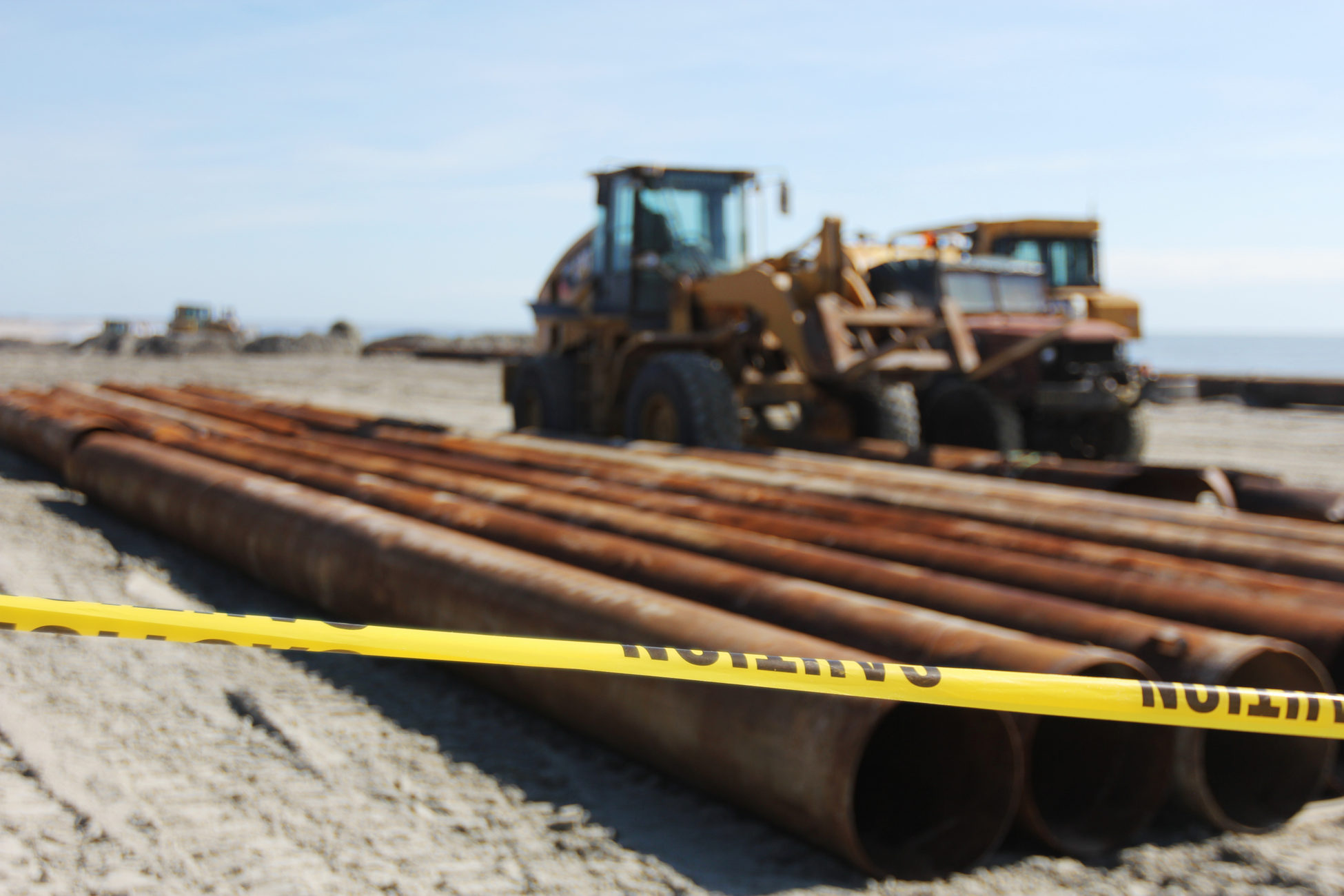 Caution tape around a construction site on the beach