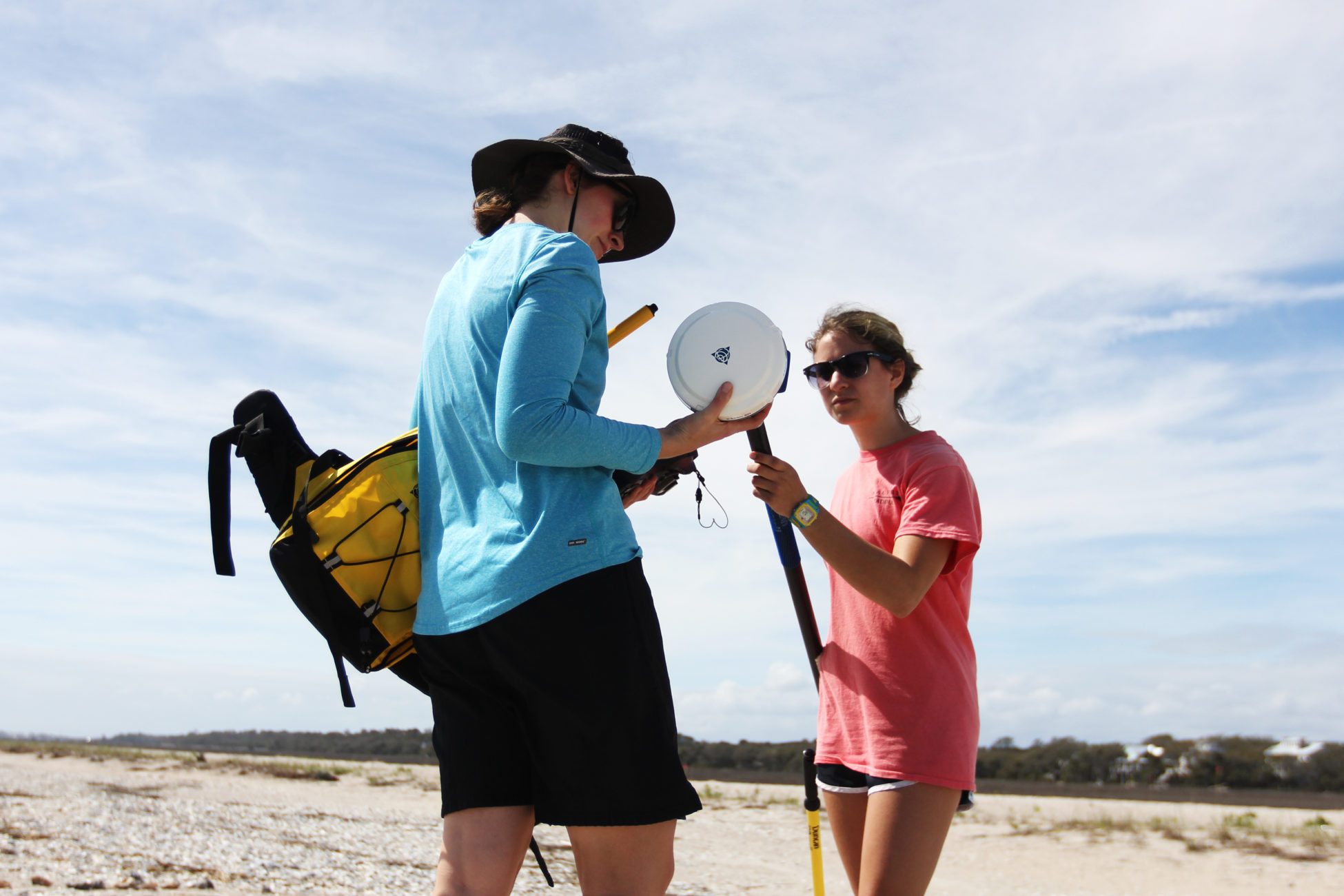 Elsemarie deVries and Atencio attach the GPS to a pole