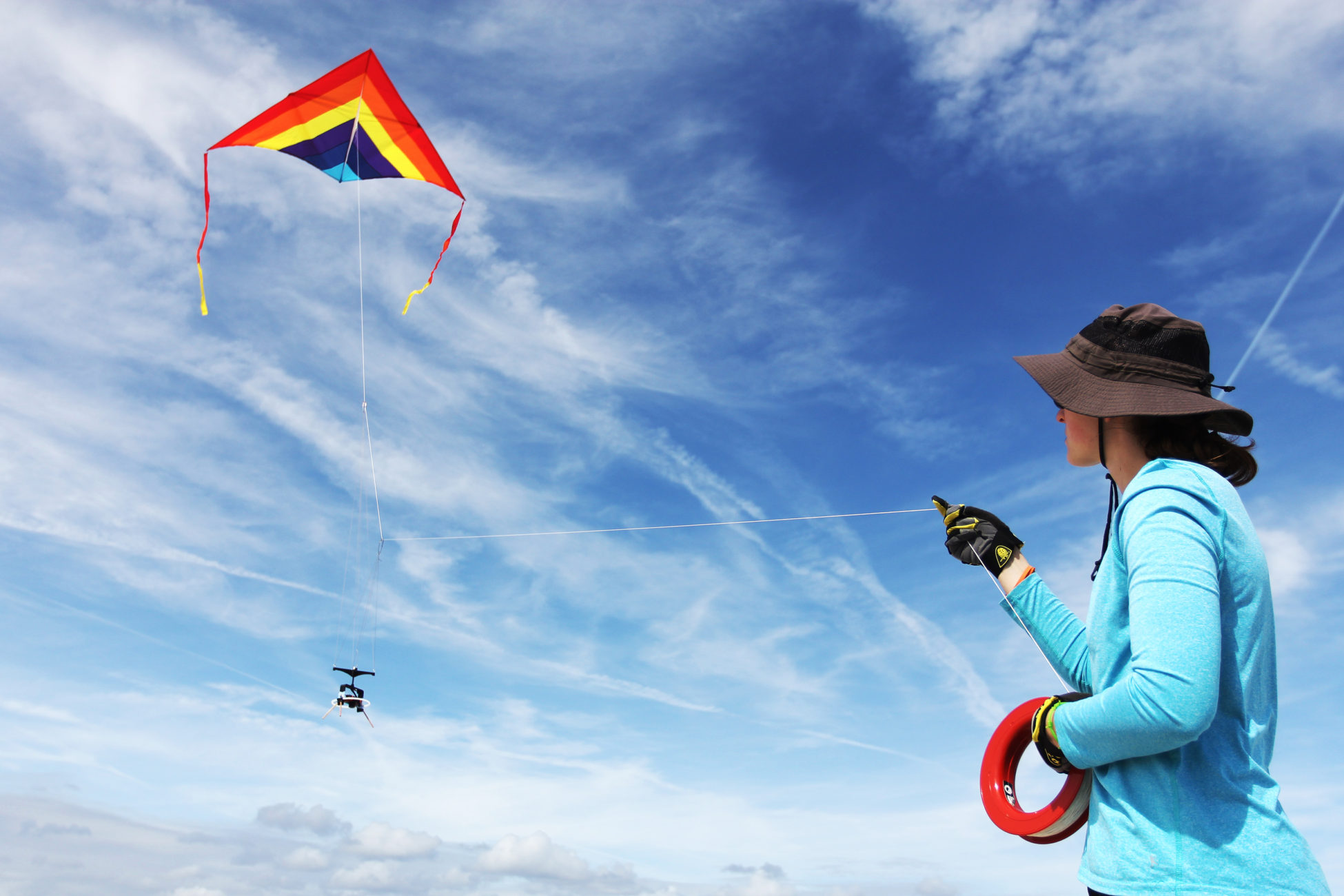 Elsemarie deVries flies a kite out on the beach with a camera attached to conduct an aerial survey