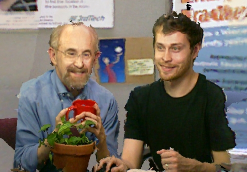 Photo of projected Henry Fuchs and Andrew Maimone testing their augmented reality headset that projects a 3D representation of a person into the wearer's view.