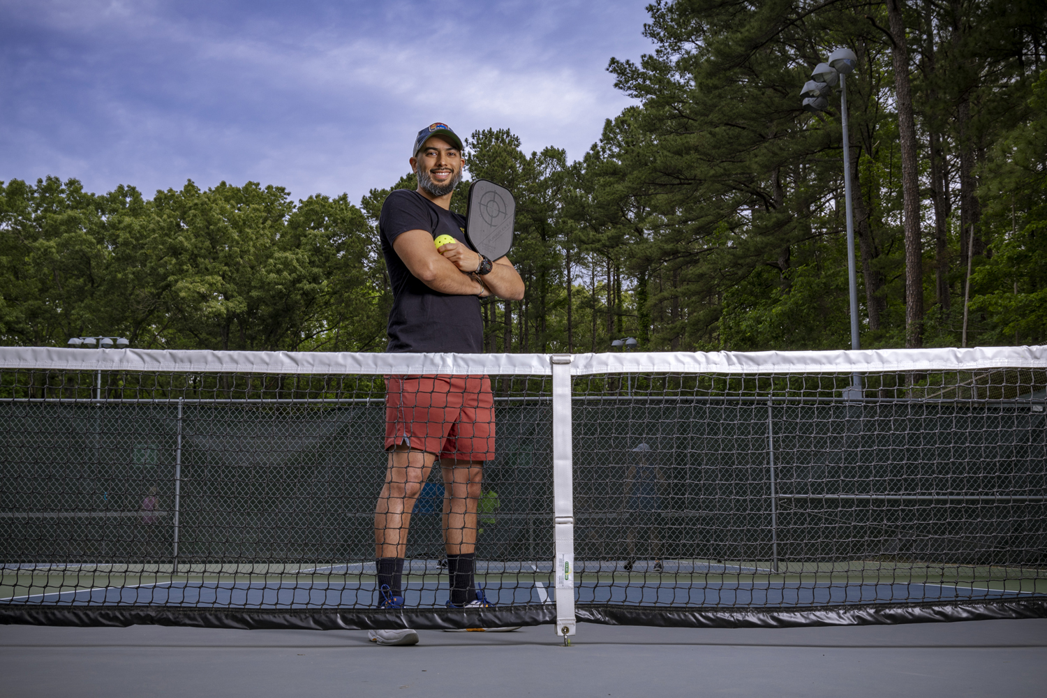 Esteban Agudo poses on a pickleball court