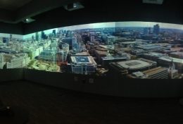 Photo of a researcher in a 360 projection room, looking over London.