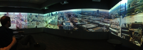 Photo of a researcher in a 360 projection room, looking over London.