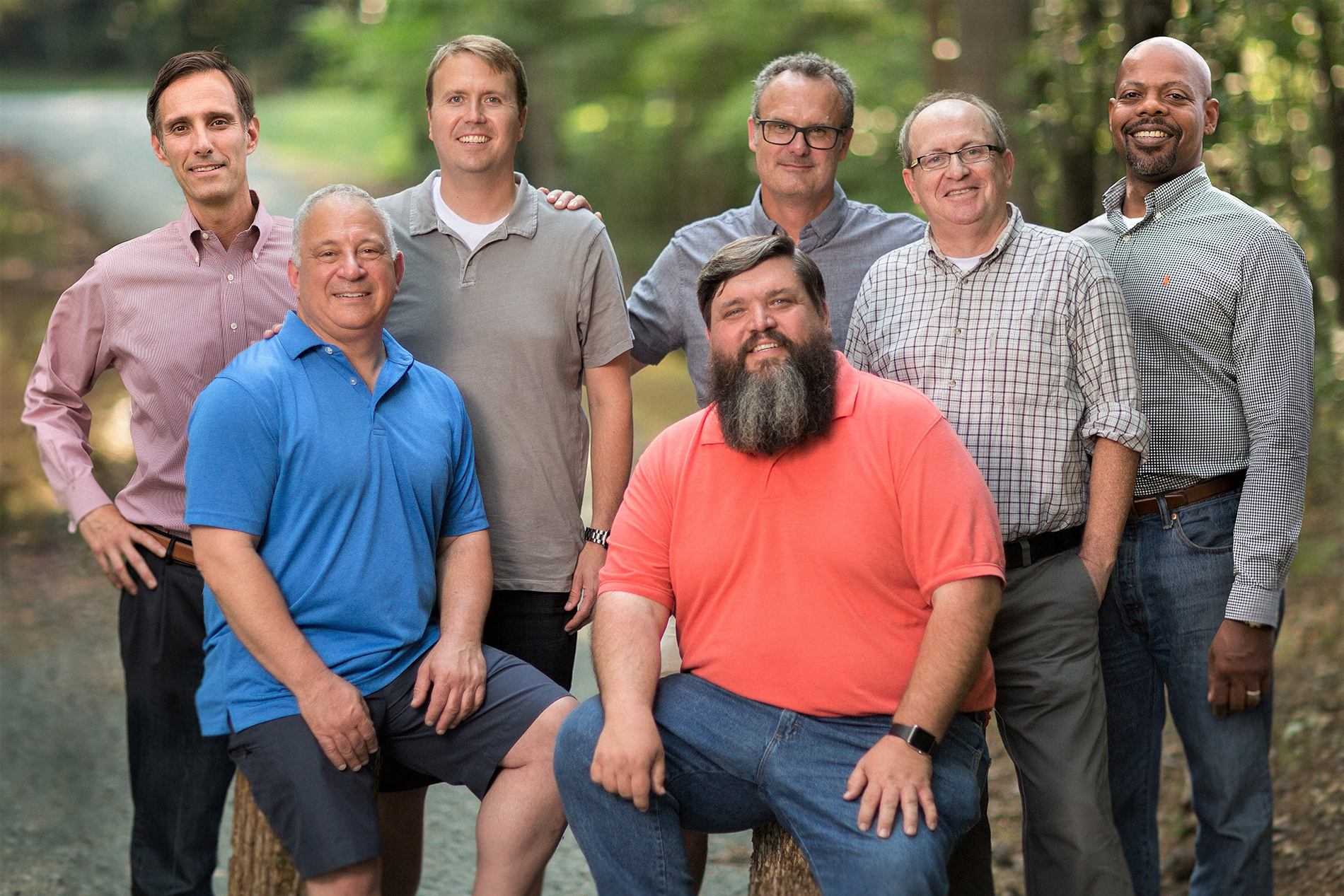 seven men from a widowed fathers support group stand together and pose for a photo