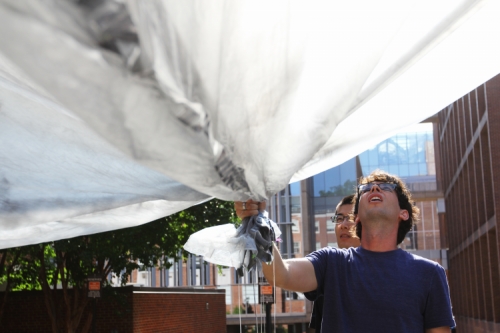 Danny Bowman holds the end of his homemade solar balloon, preparing to launch it. Click the image to start the video.