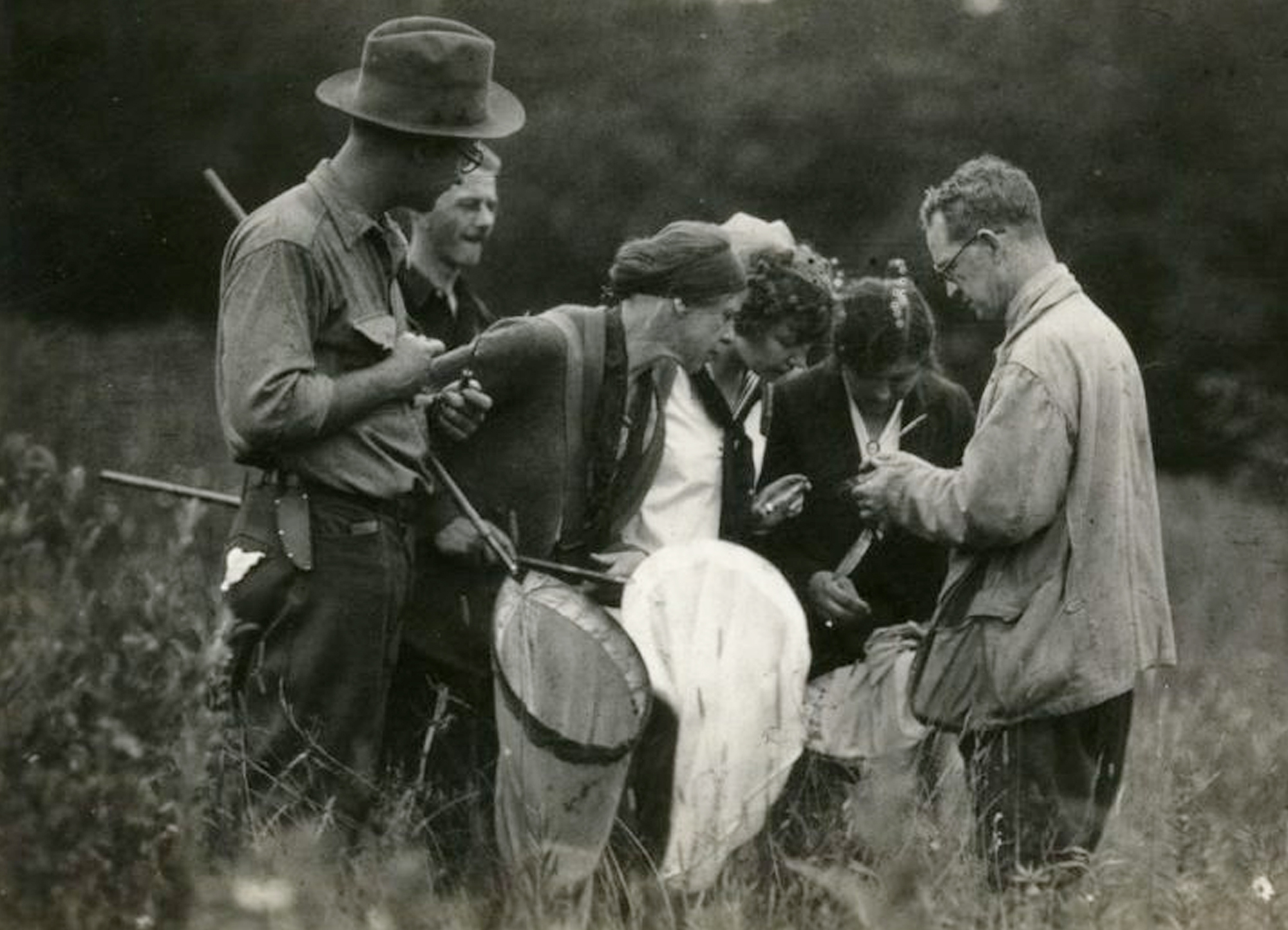 Robert Coker educates fellow researchers carrying nets out in the field