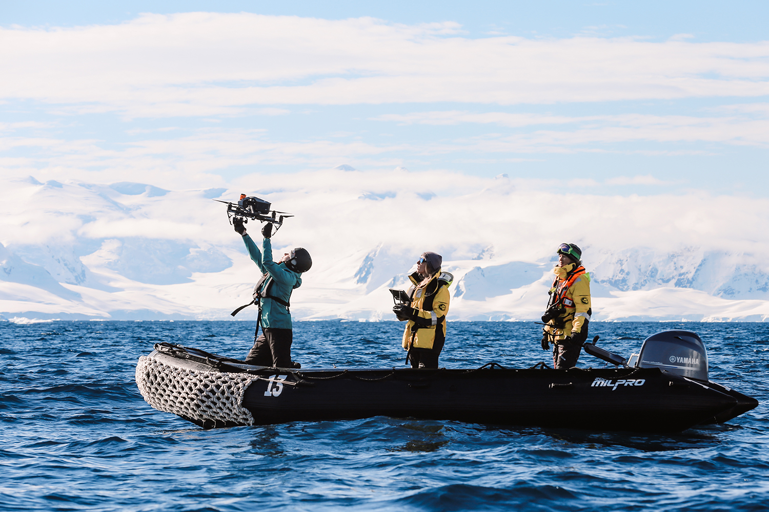 Liah McPherson, Chloe Lew, and Kiirsten Flynn fly a drone in Antarctica