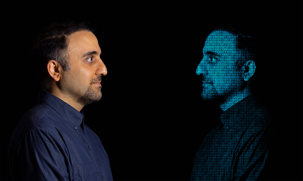 Mohammad Jarrahi looks at a mirror-image of himself made of numbers