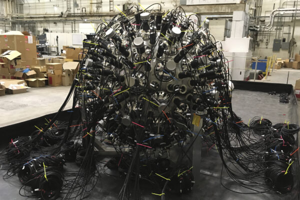 a sphere covered in nodes and black wires; the NuDot experiment from the outside