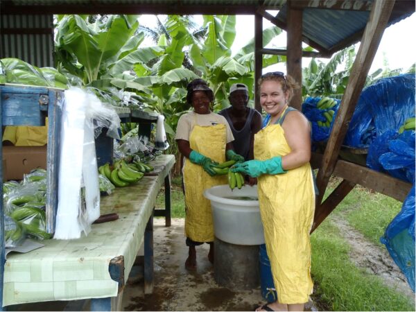 Caela O'Connell and two banana farmers in Saint Lucia