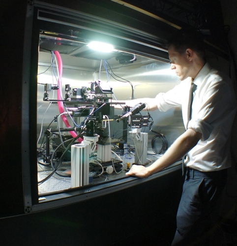 Photo of Spencer Smith working with the microscope that his lab created.