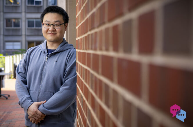 a man leans against a brick wall