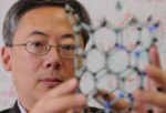 University Gazette Otto Zhou with a model of a carbon nanotube